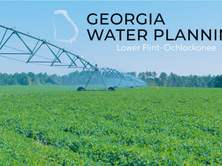 A center pivot irrigating a field in Georgia with the Georgia Water Planning Logo